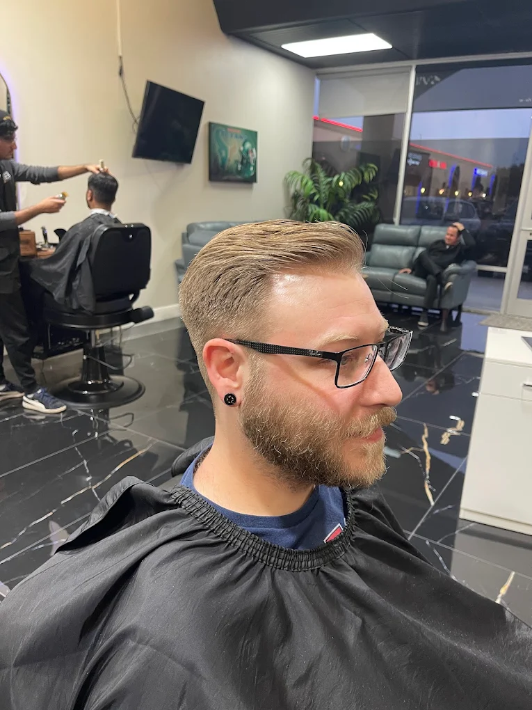 Styled haircut and beard trim in the barber chair