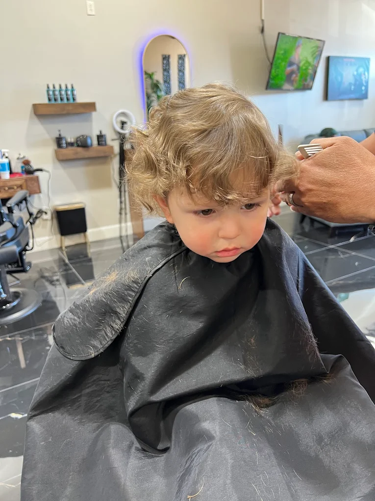 Kid haircut in progress at Amari's Barbershop