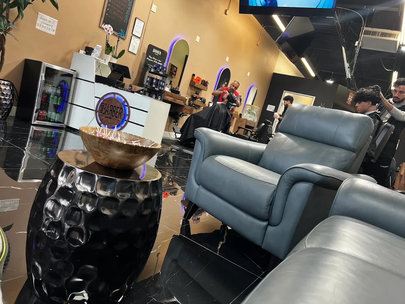 Barber lounge seating and shop interior at Amari's Barbershop